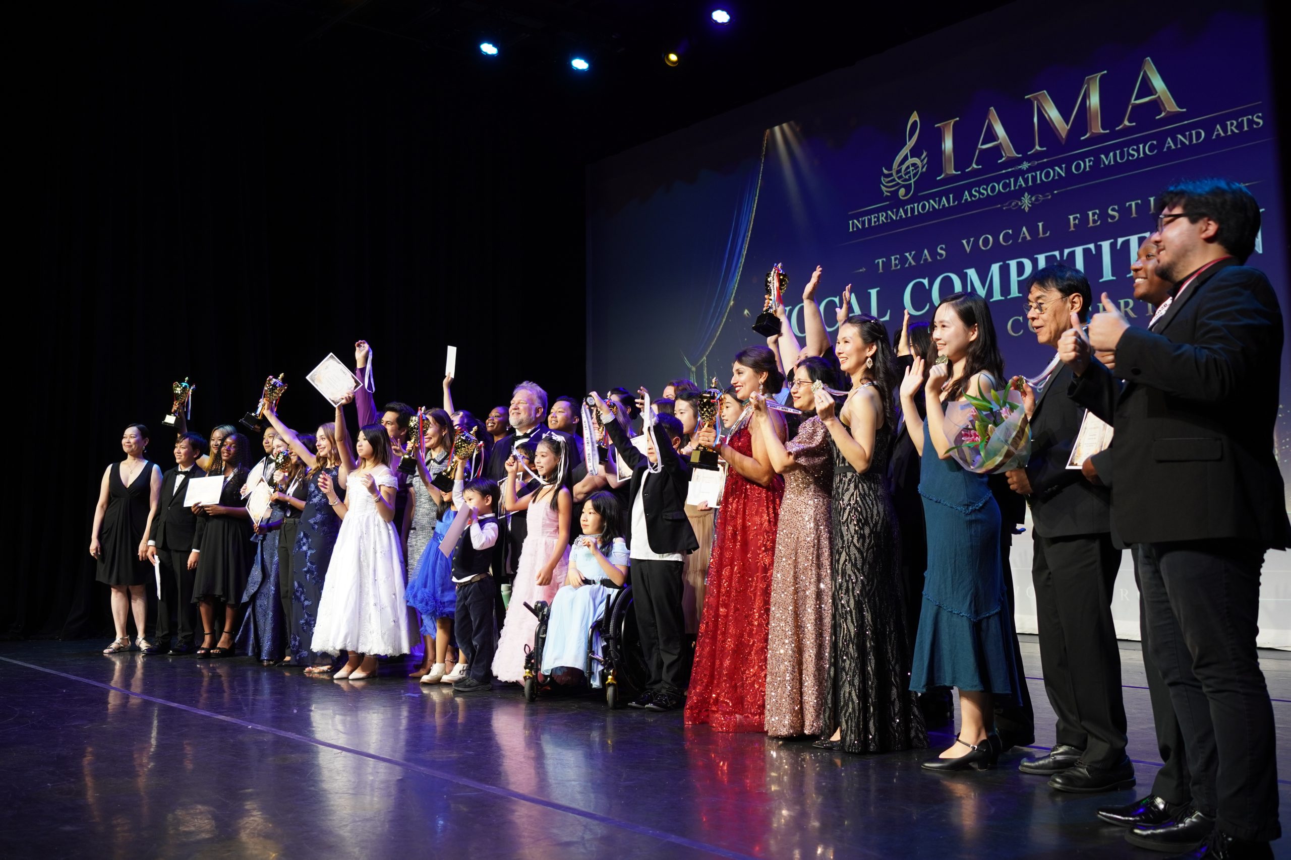 2026 IAMA award recipients, judges, and performers celebrating together on stage